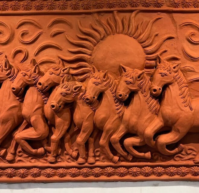 SCULPTURE DEPICTING SEVEN RUNNING HORSES WITH A RISING SUN